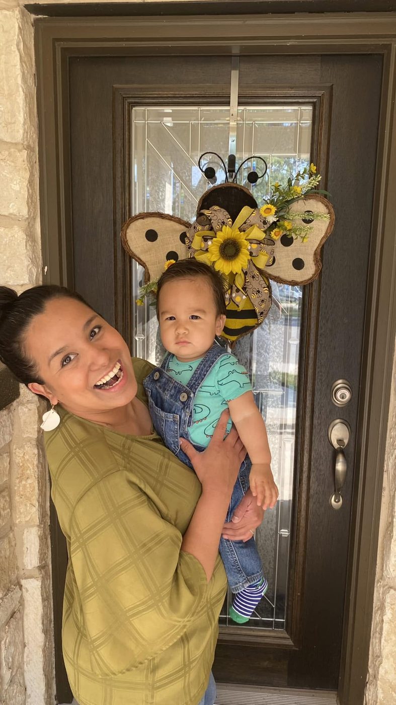 Oralia and her baby with a bumblebee sunflower door hanger