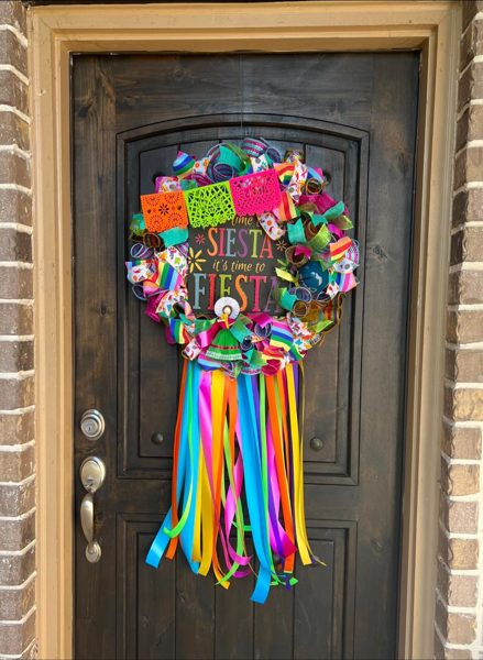 Customer's Fiesta wreath hanging on a wood front door